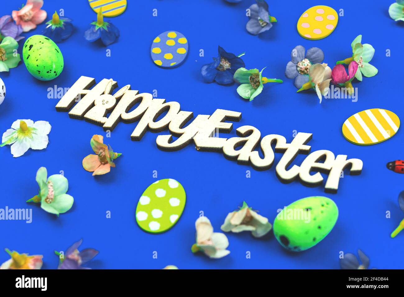 Happy Easter flat lay composition with spring easter decoration on blue background Stock Photo