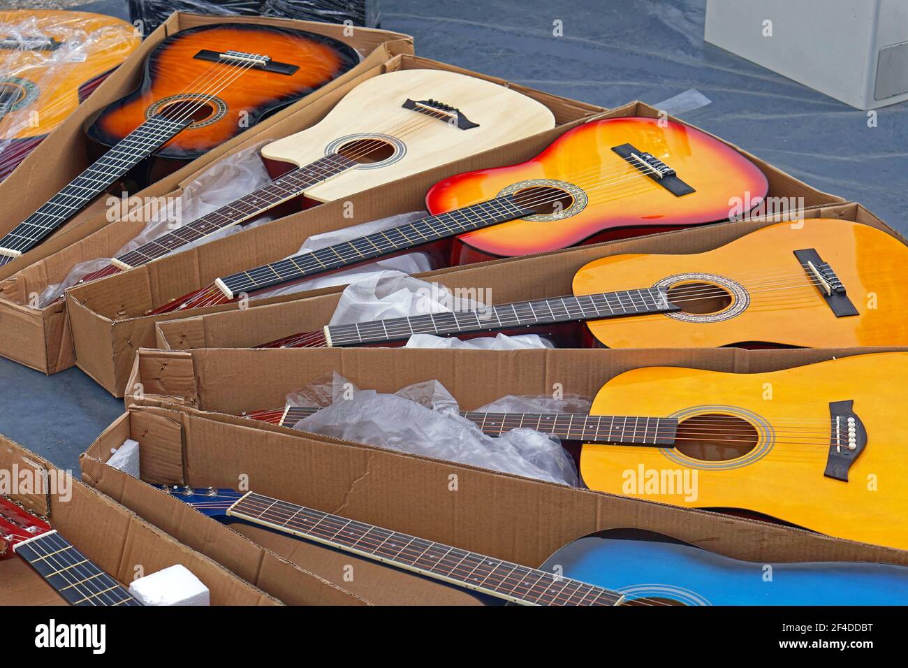 Many new colourful guitars music instruments for sale Stock Photo Alamy
