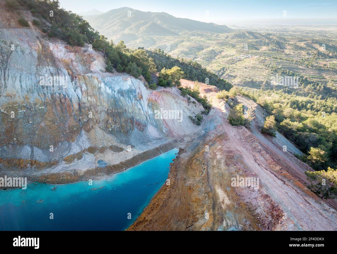 Aerial view of abandoned opencast Alestos mine in Cyprus. Blue lake and colorful rocks rich of copper and sulfide deposits Stock Photo