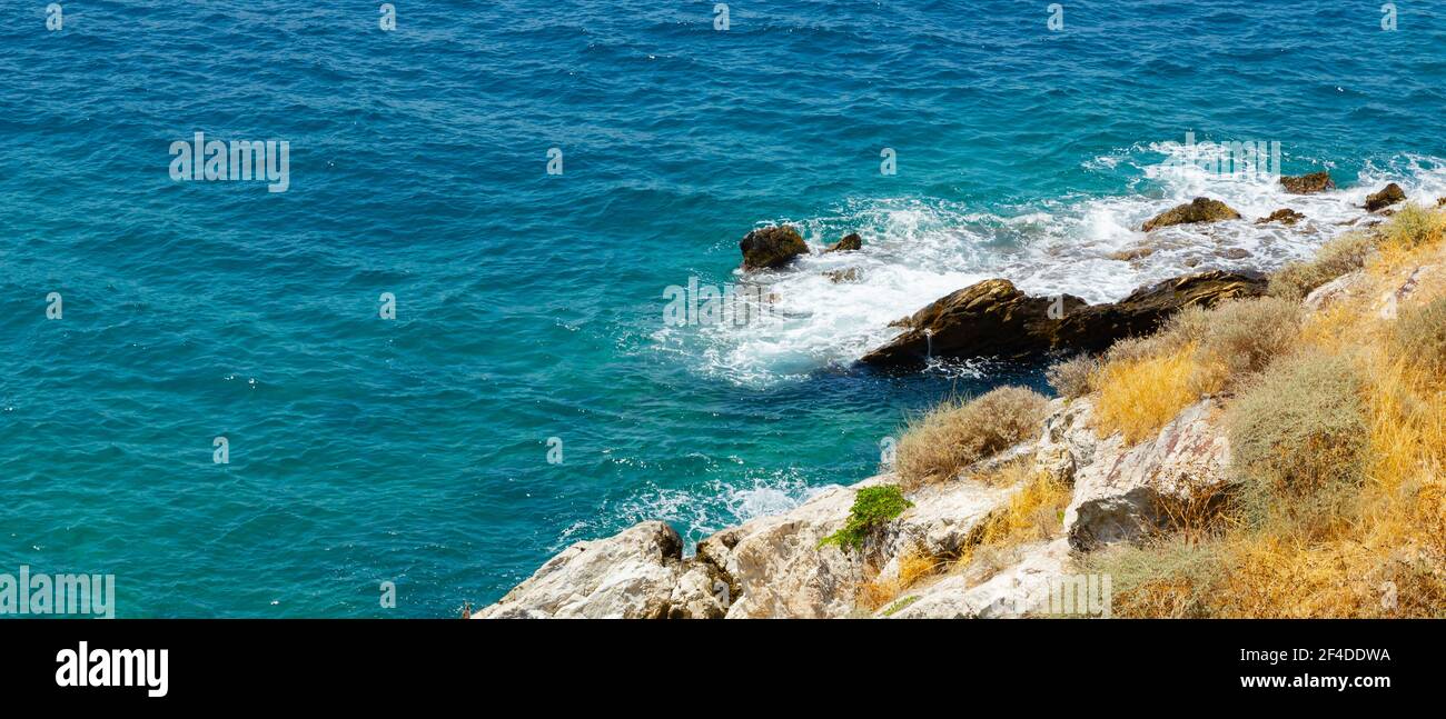 Horizontal view of the turquoise waters of the sea. Wild clifs in front of turquoise water. Summer vacation by the sea Stock Photo