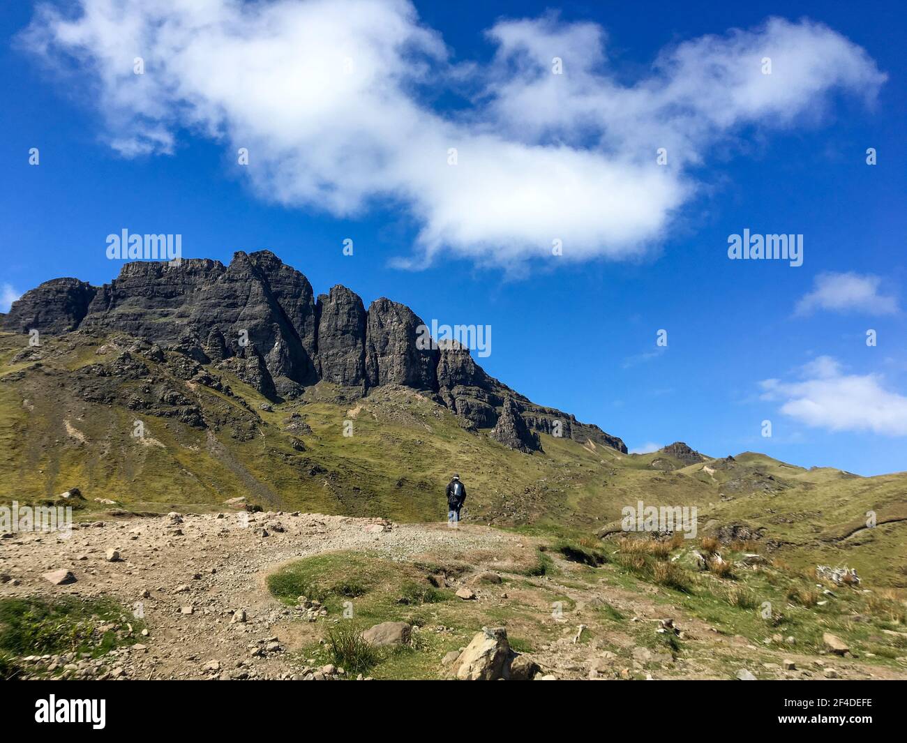 Man hiking up the Man of Storr, Isle of Skye, Inner Hebrides, Scotland, UK Stock Photo