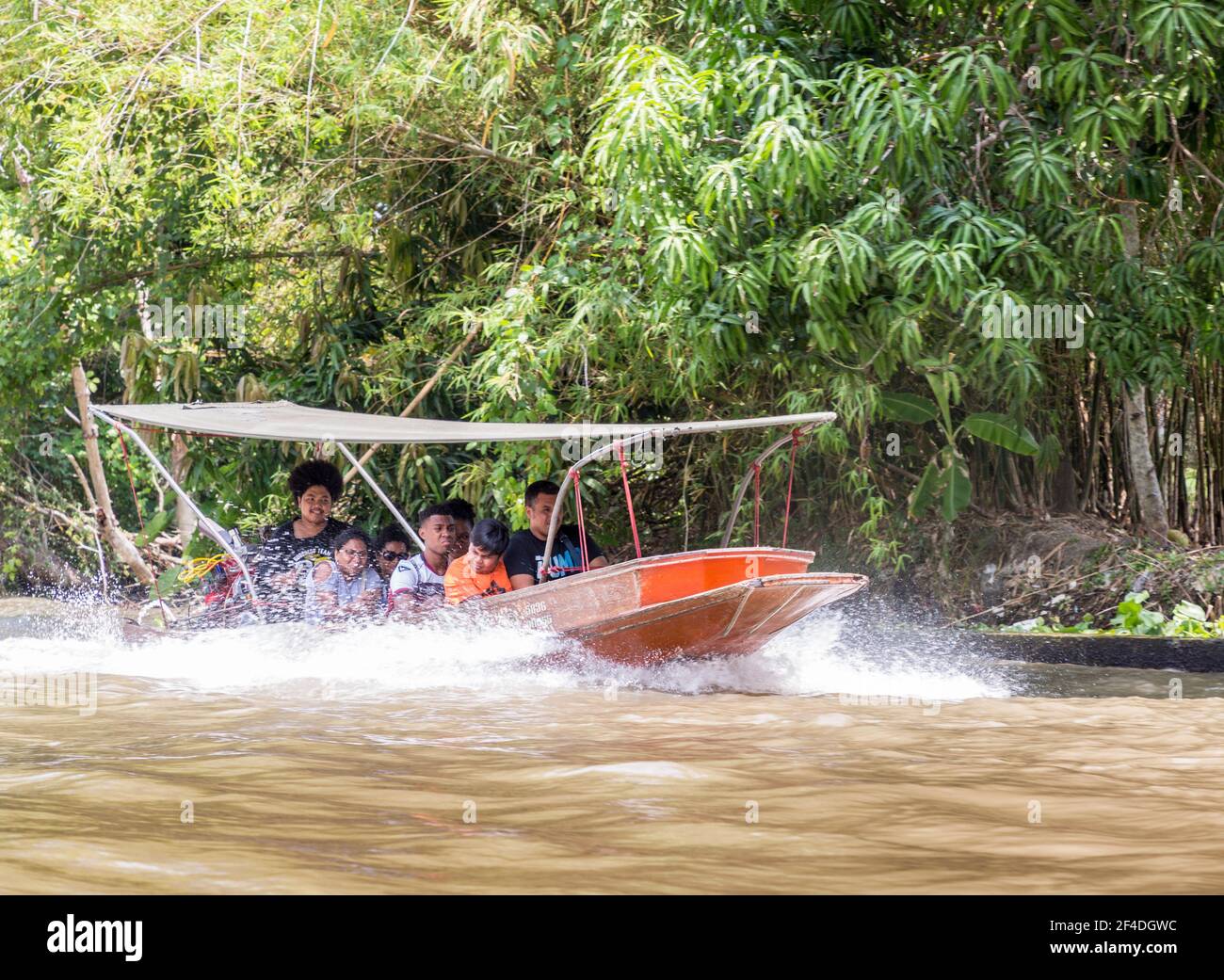 Tourists travelling by boat to the Tha Kha Floating Market, Bangkok, Thailand Stock Photo