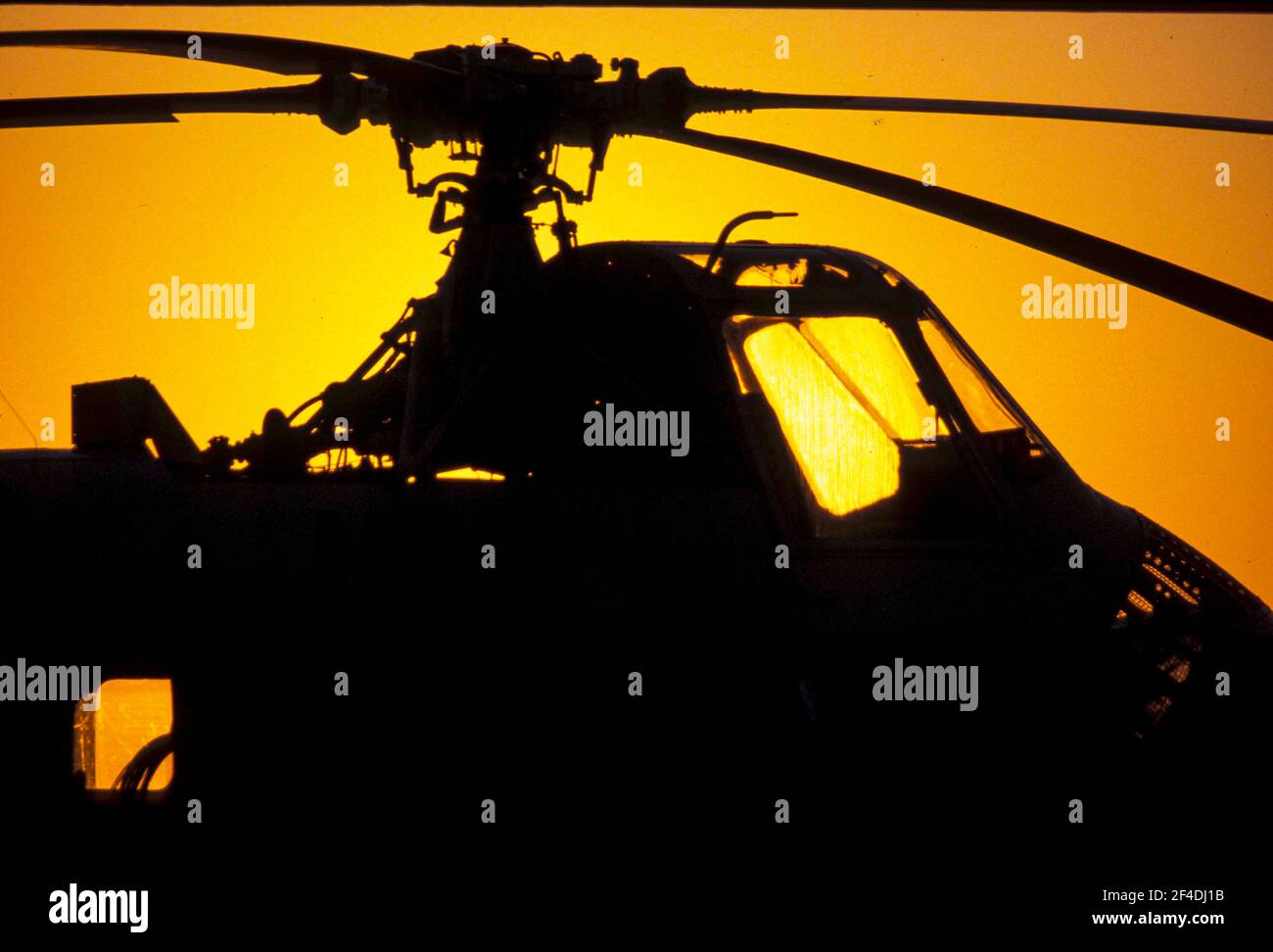 A King Bee Helicopter is silhouetted against the setting sun Stock