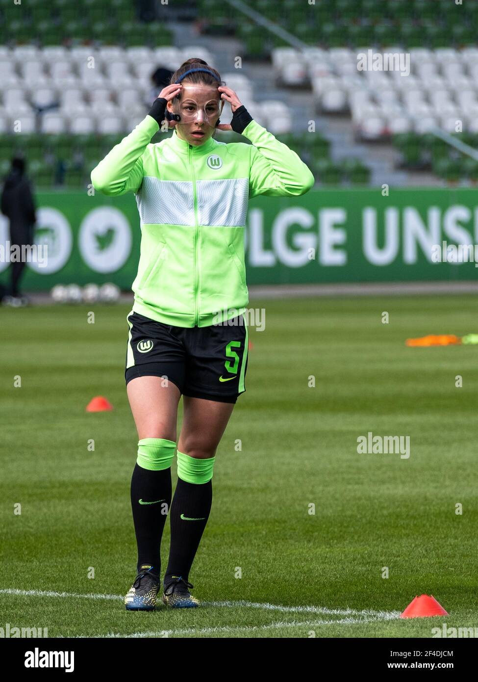 Lena Oberdorf (#5 VfL Wolfsburg) with face mask during warm up before the  DFB Cup round of 8 between VfL Wolfsburg and SV Werder Bremen at the AOK  Stadium in Wolfsburg Germany.
