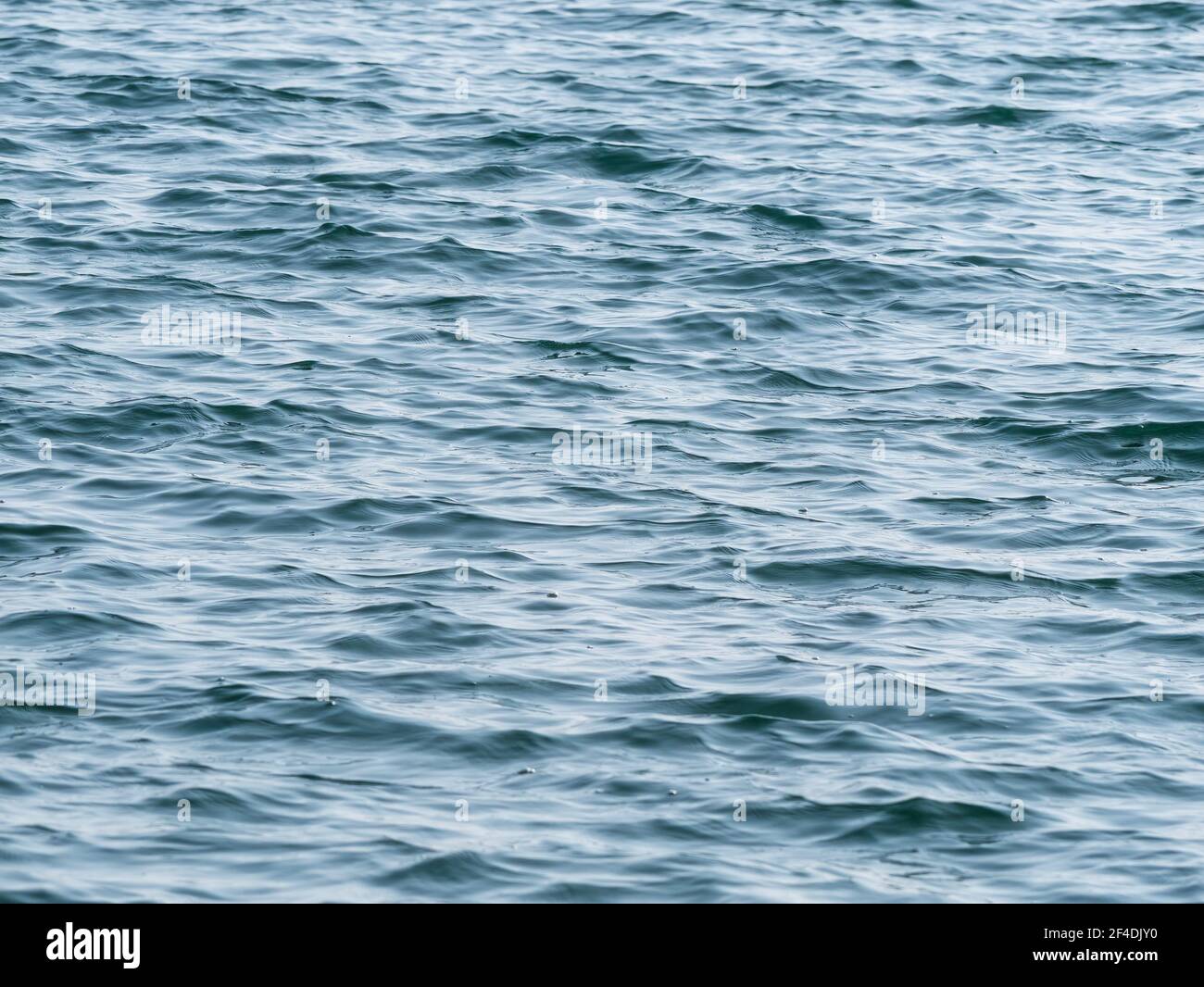 Blue sea water ripples texture background Stock Photo - Alamy