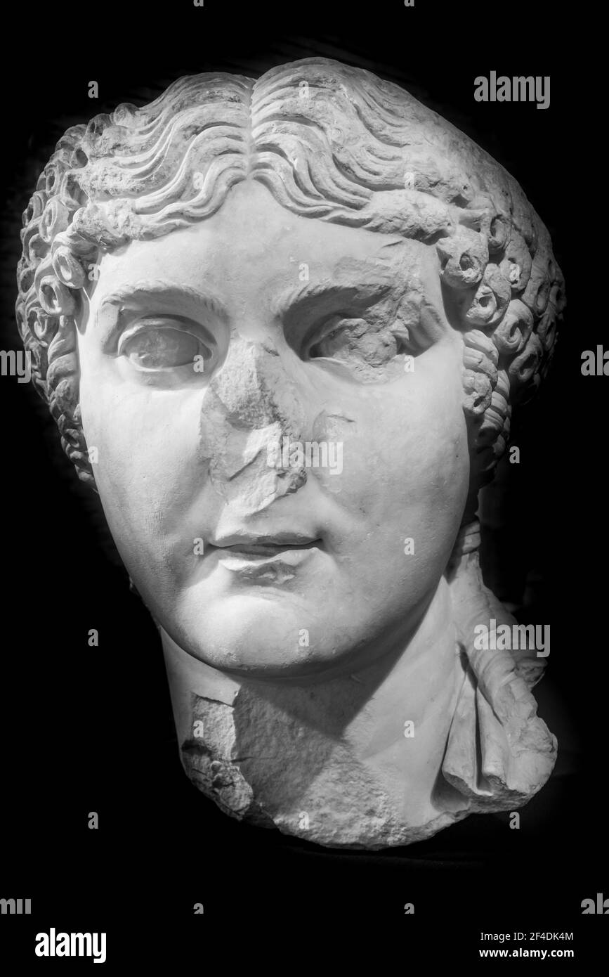 Black and white photo of ancient female roman bust in ruins Stock Photo