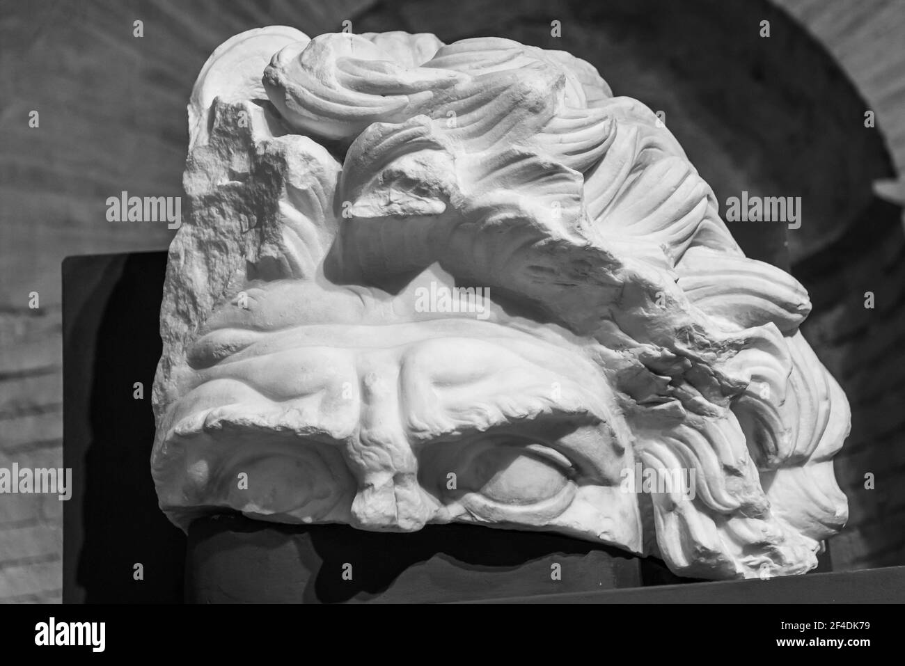 Black and white photo of upper part of male head sculpted in marble Stock Photo