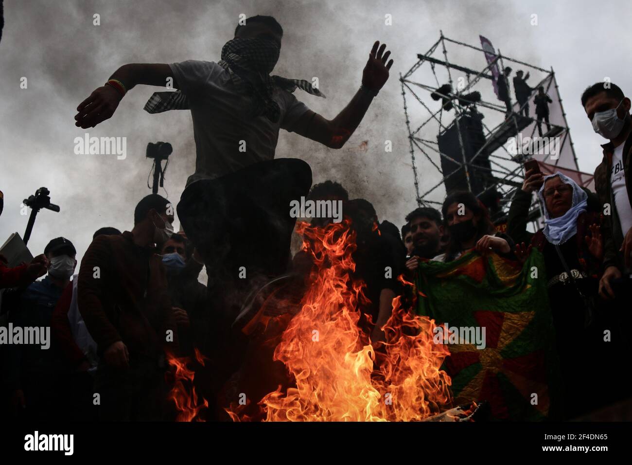 Istanbul, Turkey. 20th Mar, 2021. A man jumping over a burning fire during the celebration.Newroz originated in Persia in the religious tradition of Zoroastrianism. It is considered to be the most important festival in Kurdish culture, which celebrates the arrival of the spring and the New Year. This festival has become a celebration of the Kurdish identity and symbol for the revolution and struggle of Kurds throughout history. (Photo by Hakan Akgun/SOPA Images/Sipa USA) Credit: Sipa USA/Alamy Live News Stock Photo