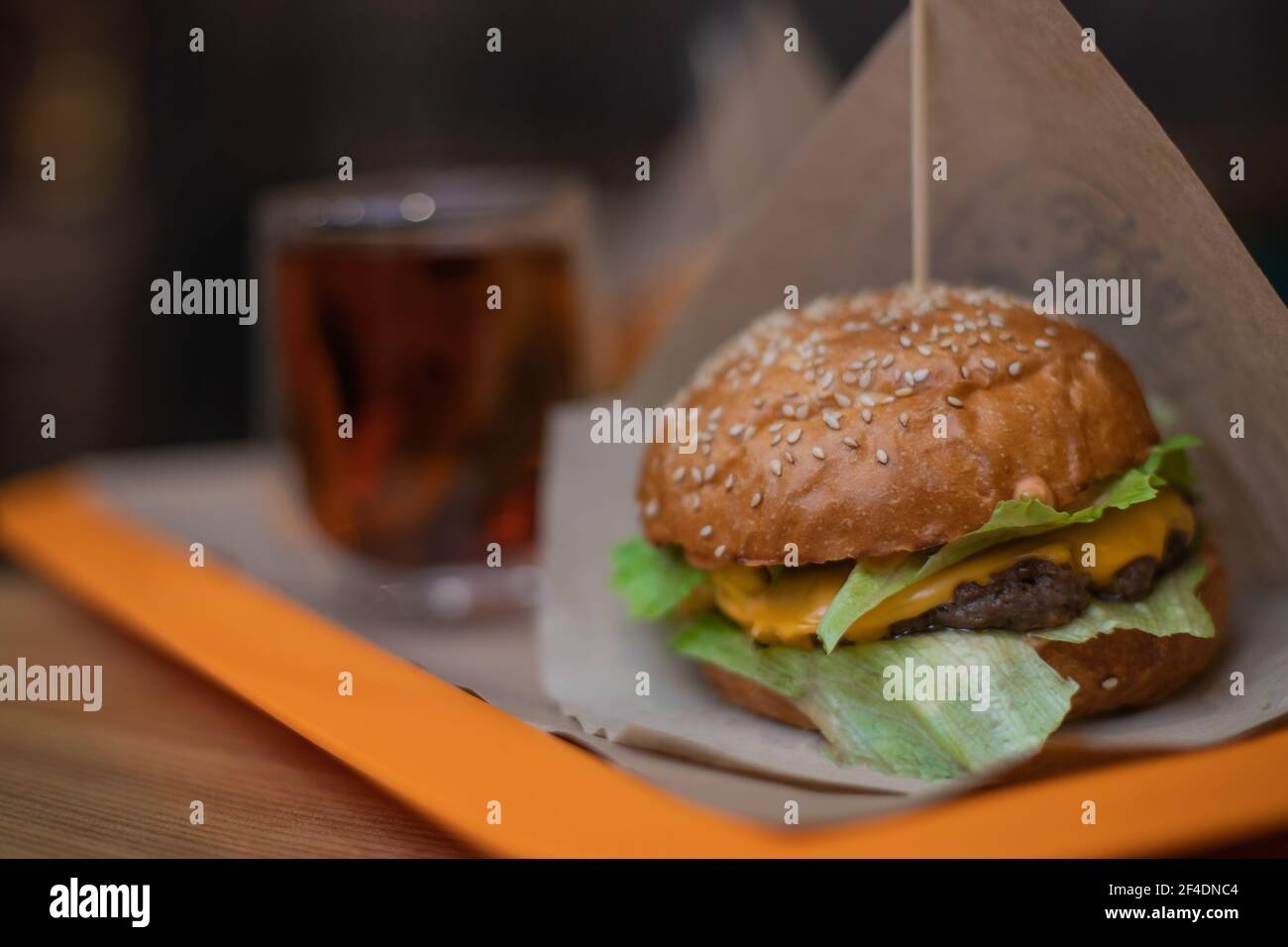 Burger with beef cutlet, corn, cheese, salad. Fast food. Stock Photo