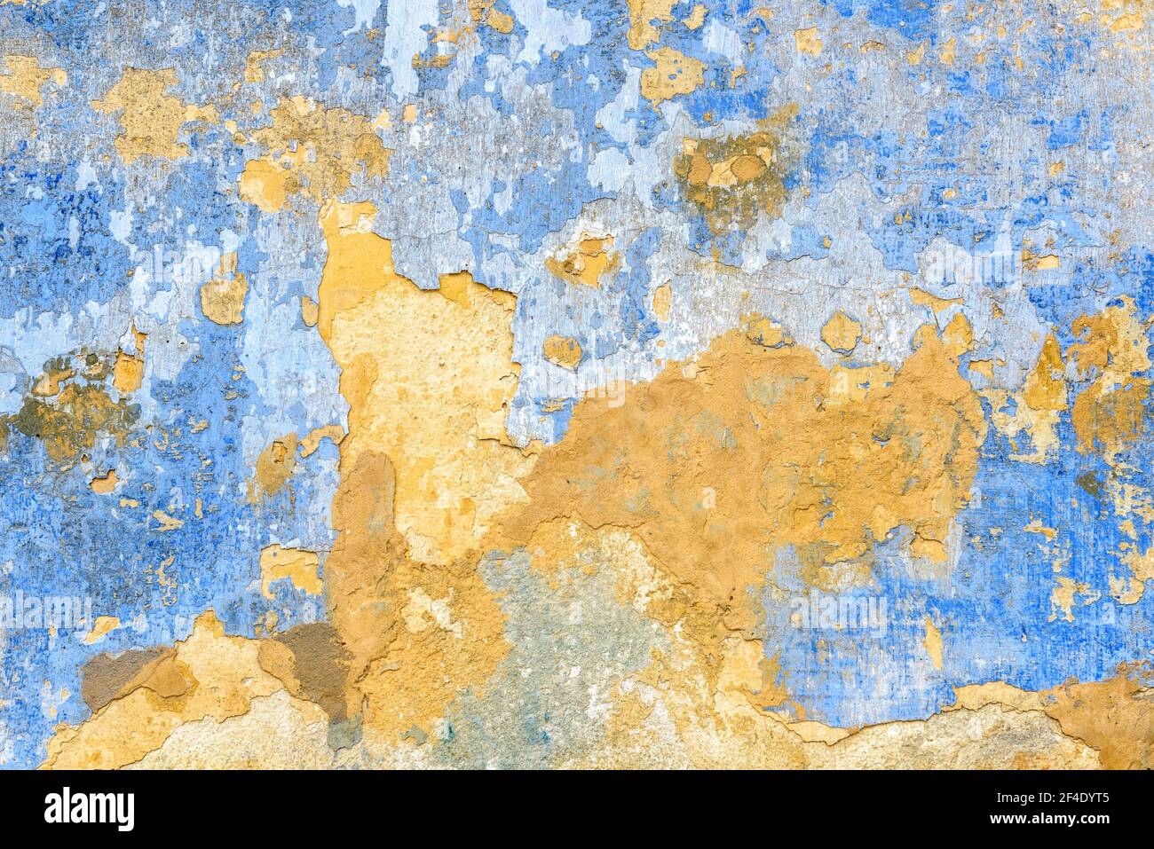 Old wall texture background, broken plaster for backdrop or wallpaper.  Rough peeling stone wall surface painted in yellow and blue colors. Cracked  gru Stock Photo - Alamy