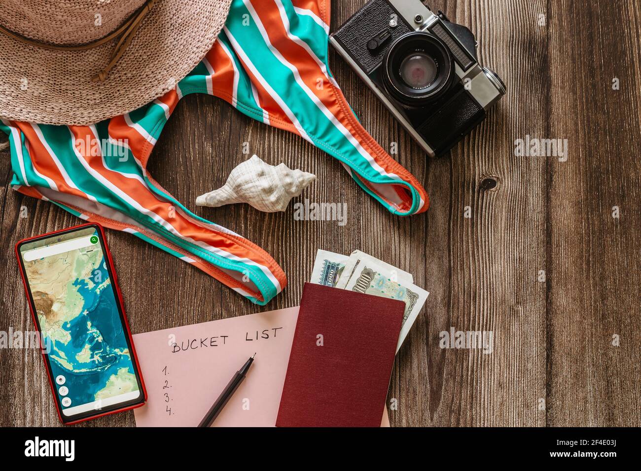 Travel concept banner flat lay.Items for summer vacation: passport,swimsuit,hat,money,smartphone with Asia map,retro camera copy space.Top view Stock Photo
