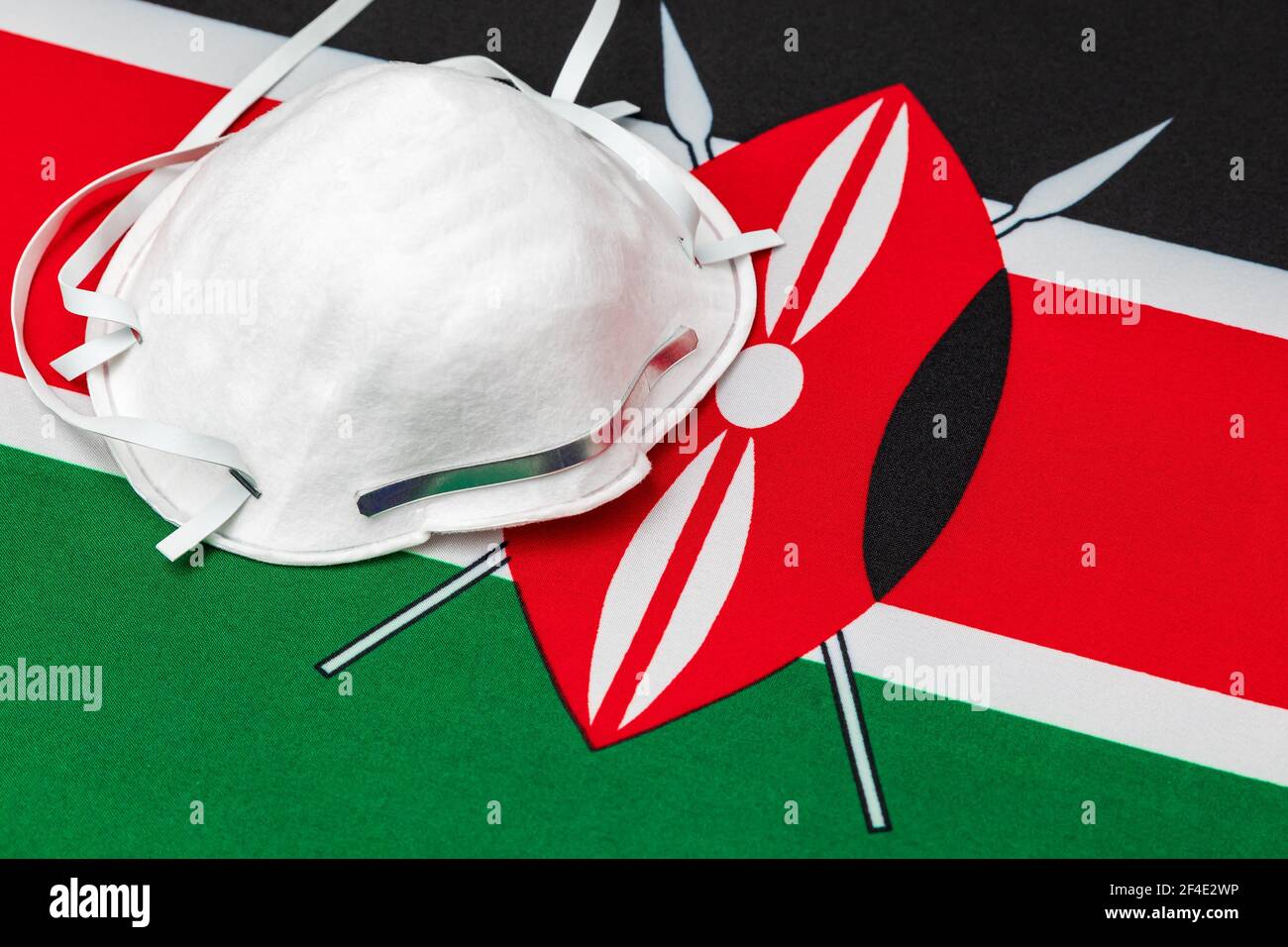 Kenya flag and N95 face mask. Concept of Covid-19 coronavirus lockdown, travel ban and healthcare crisis Stock Photo