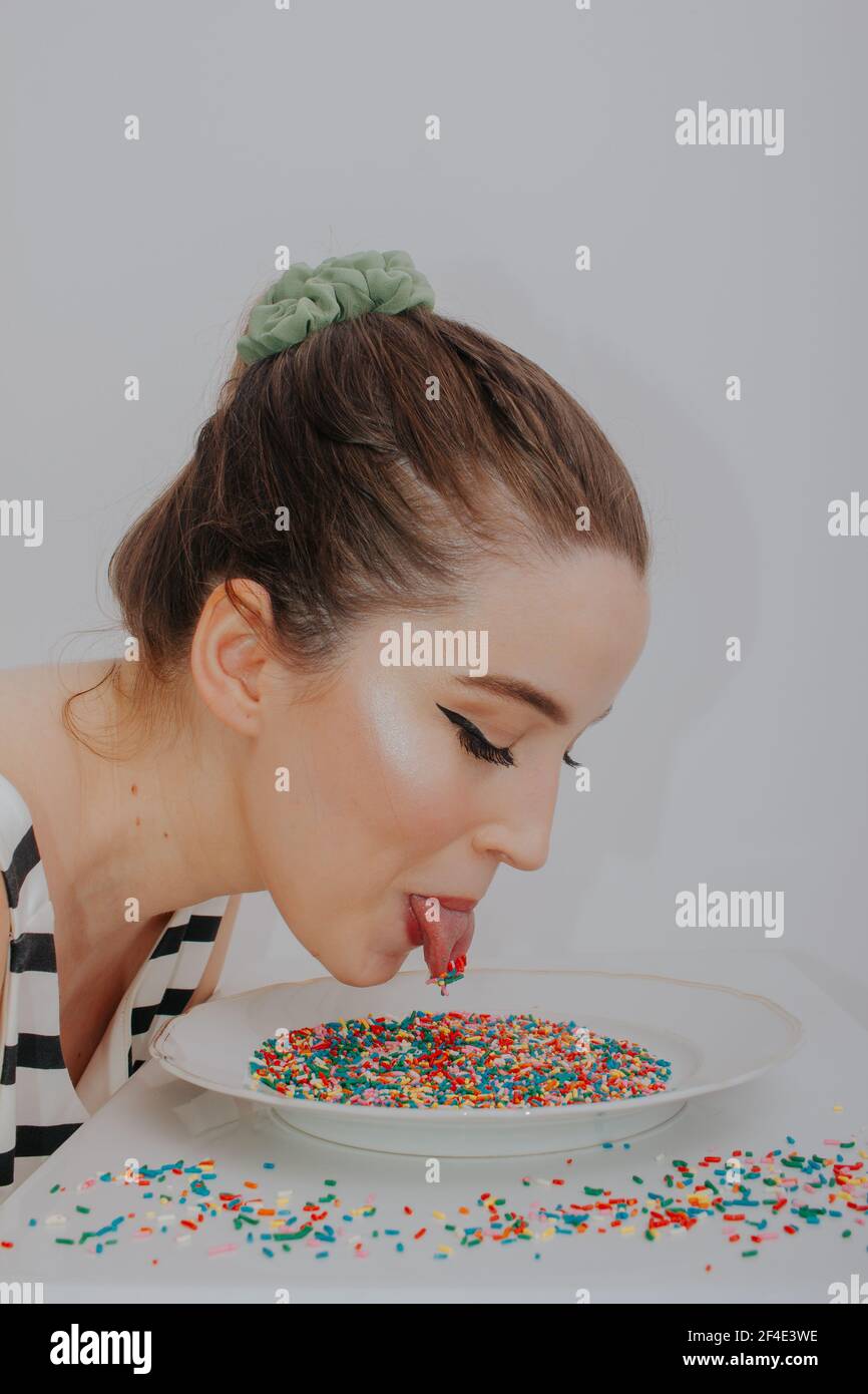 Woman with candy colorful confetti Stock Photo - Alamy