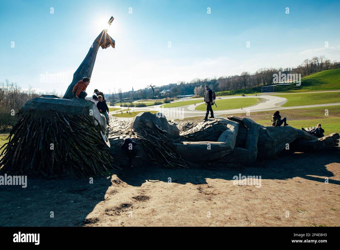 (210321) -- BOOM, March 21, 2021 (Xinhua) -- People view two 'trolls' at the De Schorre forest park in Boom, Belgium, March 20, 2021. Danish artist Thomas Dambo and his team built seven giant 'trolls' from reclaimed wood at the De Schorre forest park in northern Belgium in 2019. These giant wooden sculptures are dotted around the forest. The United Nations General Assembly proclaimed March 21 as the International Day of Forests which celebrates and creates awareness on the importance of all types of forests and on the need to preserve and care for the world's woodlands. This year the them Stock Photo