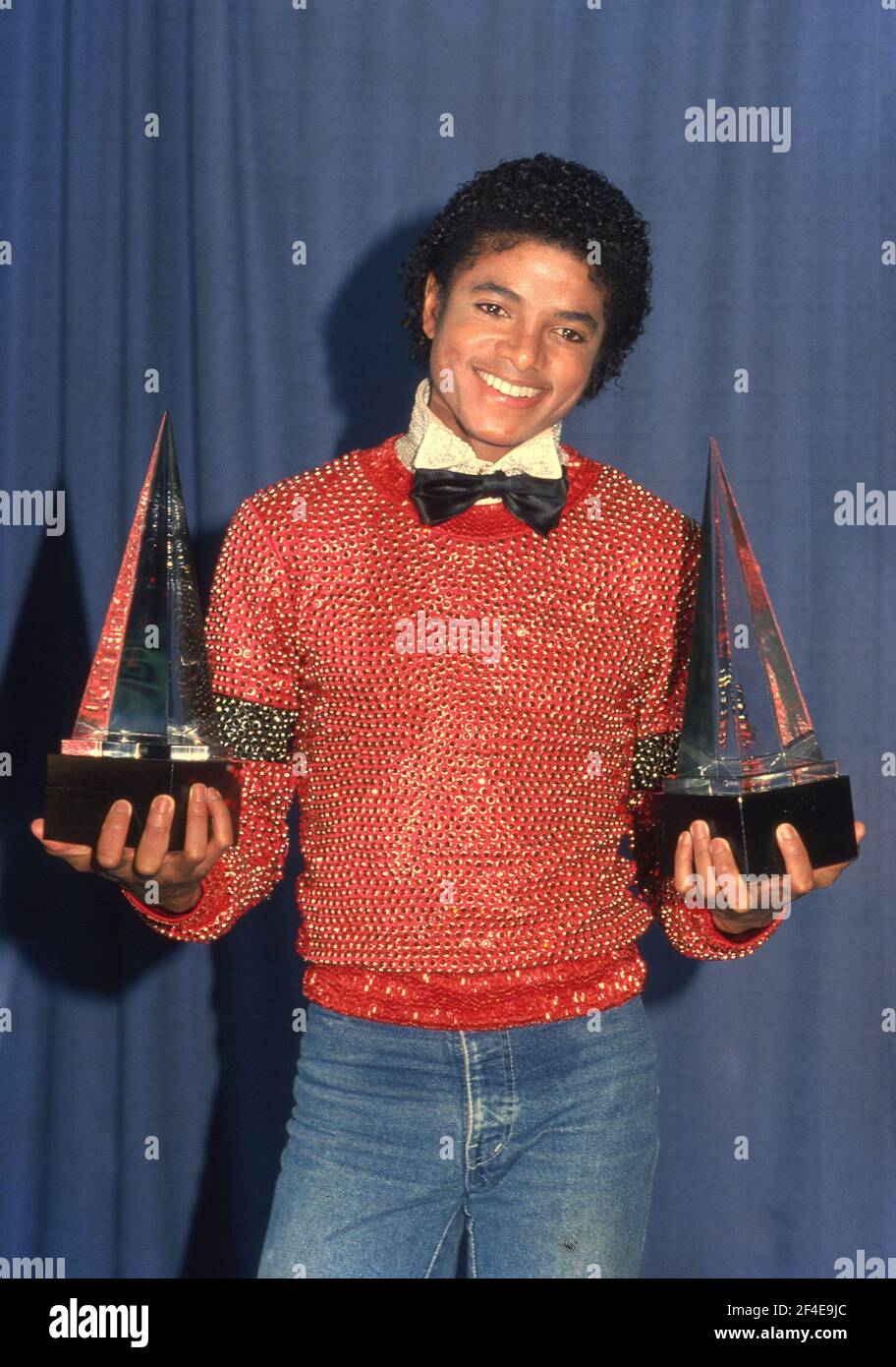 Michael Jackson carries the two American Music Awards he won for his album 'Off the Wall,' they are for Favorite Male Vocalist - Soul and R&B, and Favorite Album - Soul and R&B, Los Angeles, January 30, 1981. Credit: Ralph Dominguez/MediaPunch Stock Photo