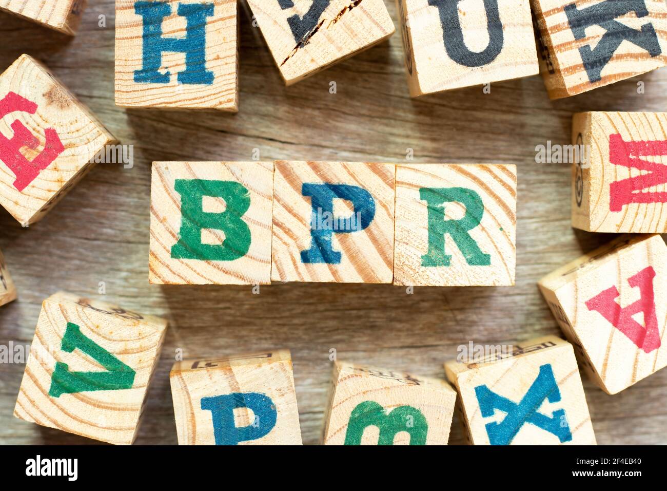 Alphabet letter block in word BPR (Abbreviation of Business Process Reengineering or Batch processing record) with another on wood background Stock Photo