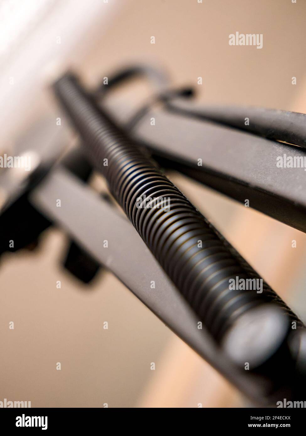 Black spring on metal construction - selective focus Stock Photo