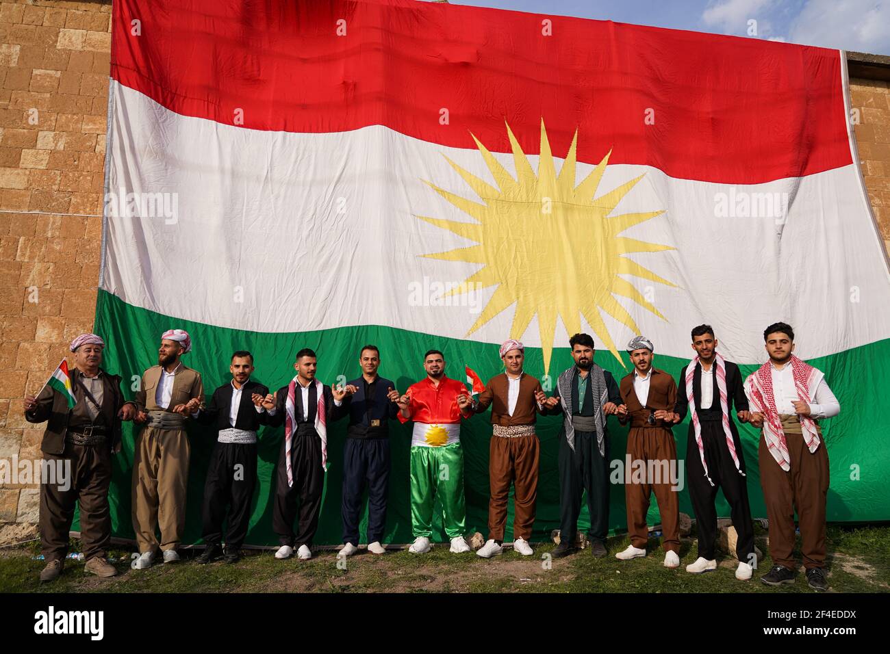 Iraqi Kurds dancing next to the Kurdistan flag during the Nowruz ...