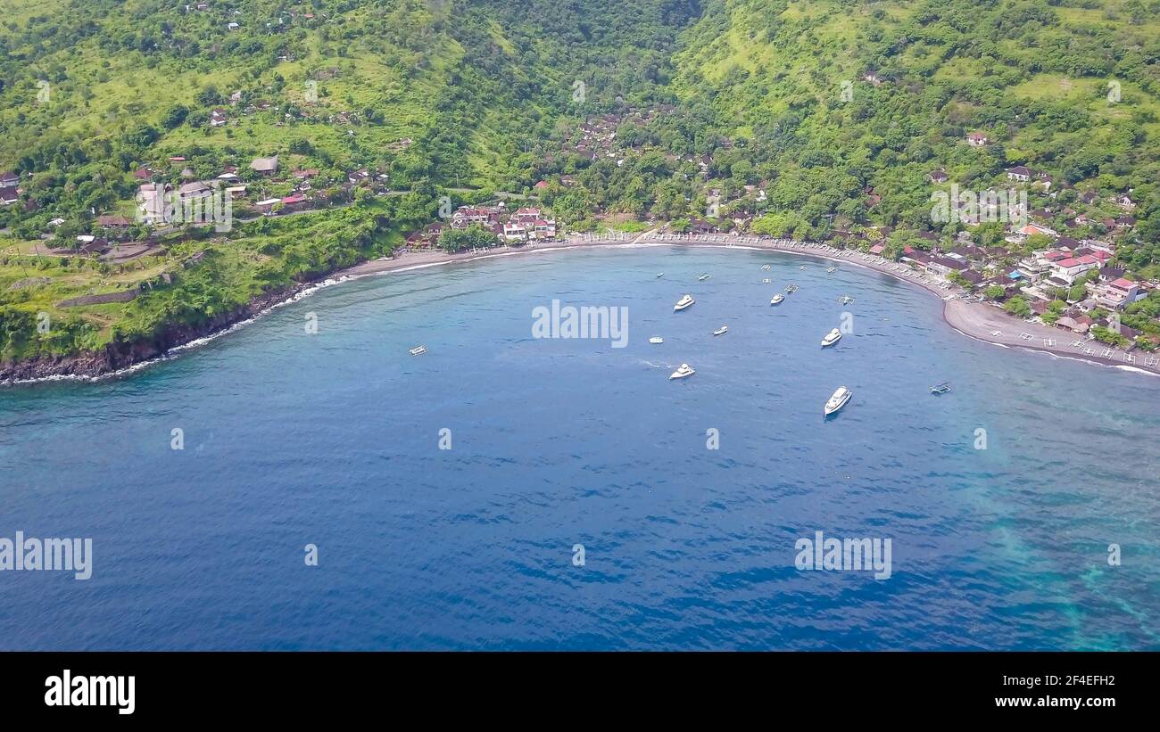 Aerial drone view from the sea to the Jemeluk Bay. Amed is fast becoming a popular tourist destination in Bali, Indonesia. It is a home to excellent Stock Photo