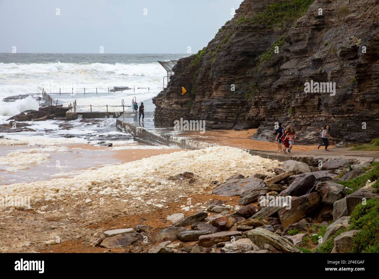 Avalon Beach,Sydney, Australia 21st March 2021.As floods batter New South Wales the east coast surf batters the coastline. Sea foam or spume is brought onto the sand Stock Photo