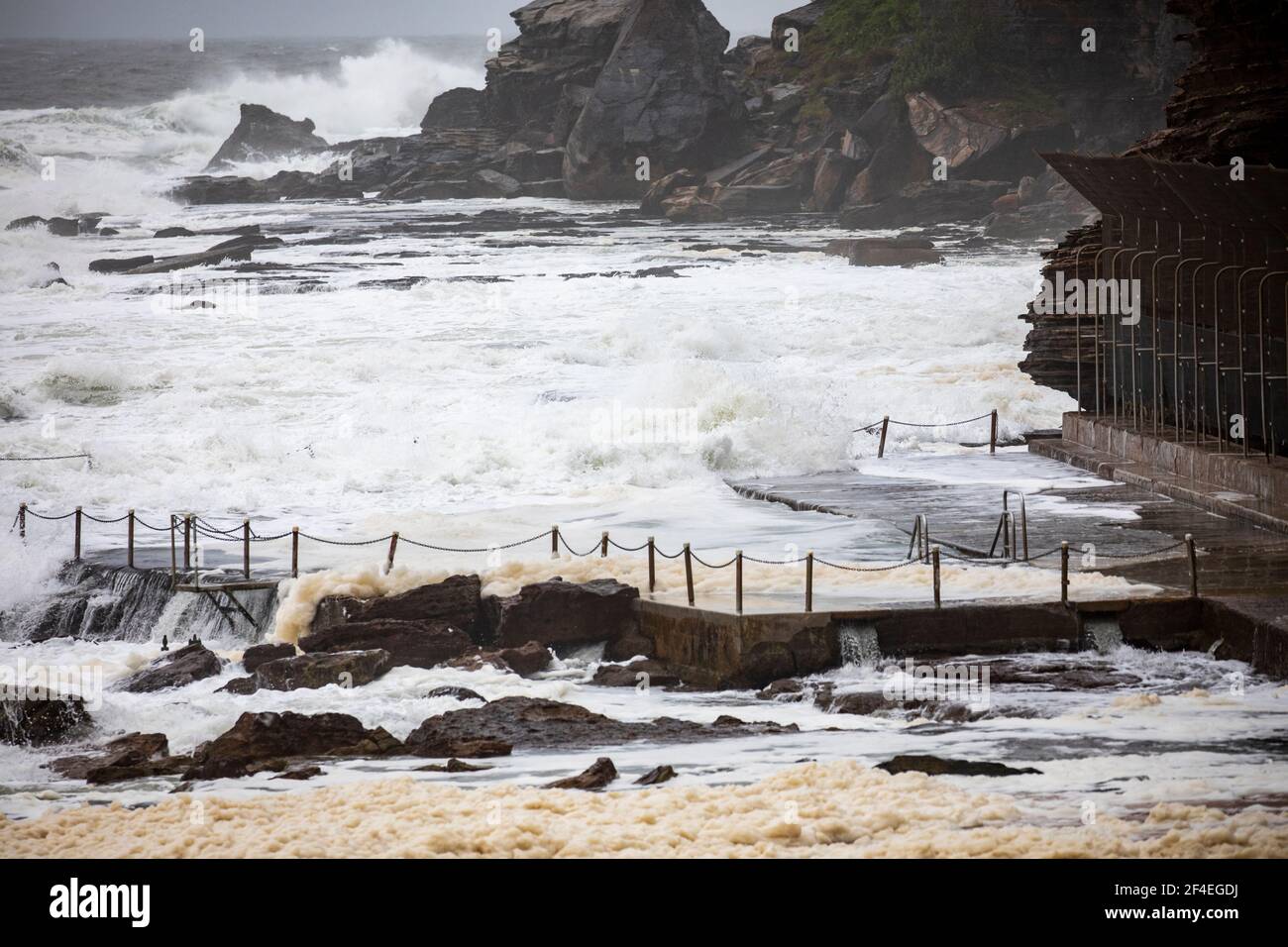 Avalon Beach,Sydney, Australia 21st March 2021.As floods batter New South Wales the east coast surf batters the coastline. Sea foam or spume is brought onto the sand Stock Photo