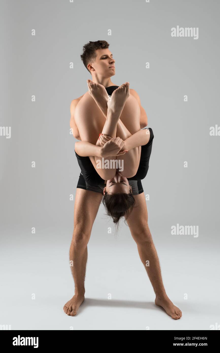 Shirtless male carrying young female during dance Stock Photo