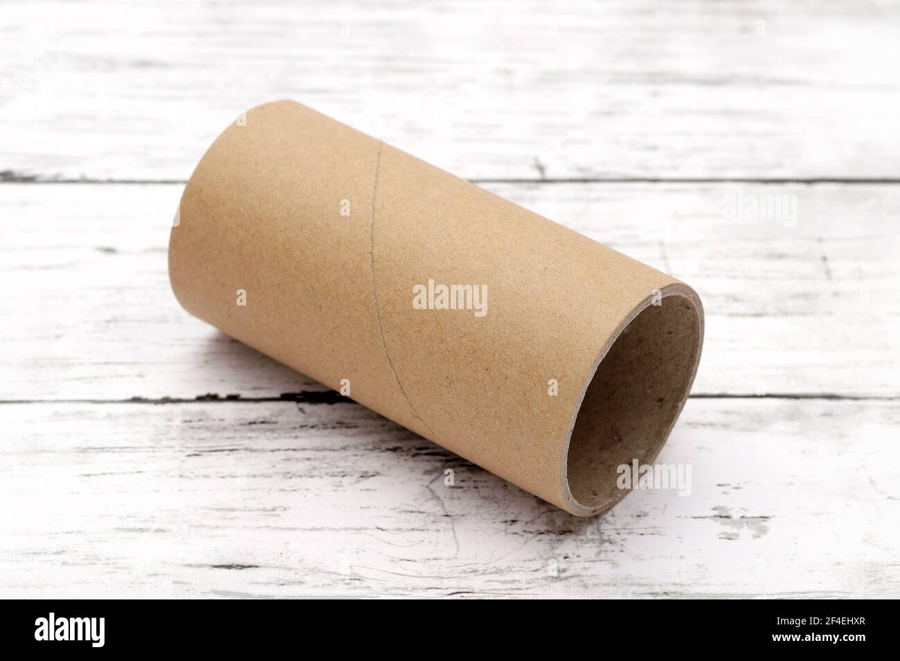 Cardboard cylinders on a white wooden table Stock Photo