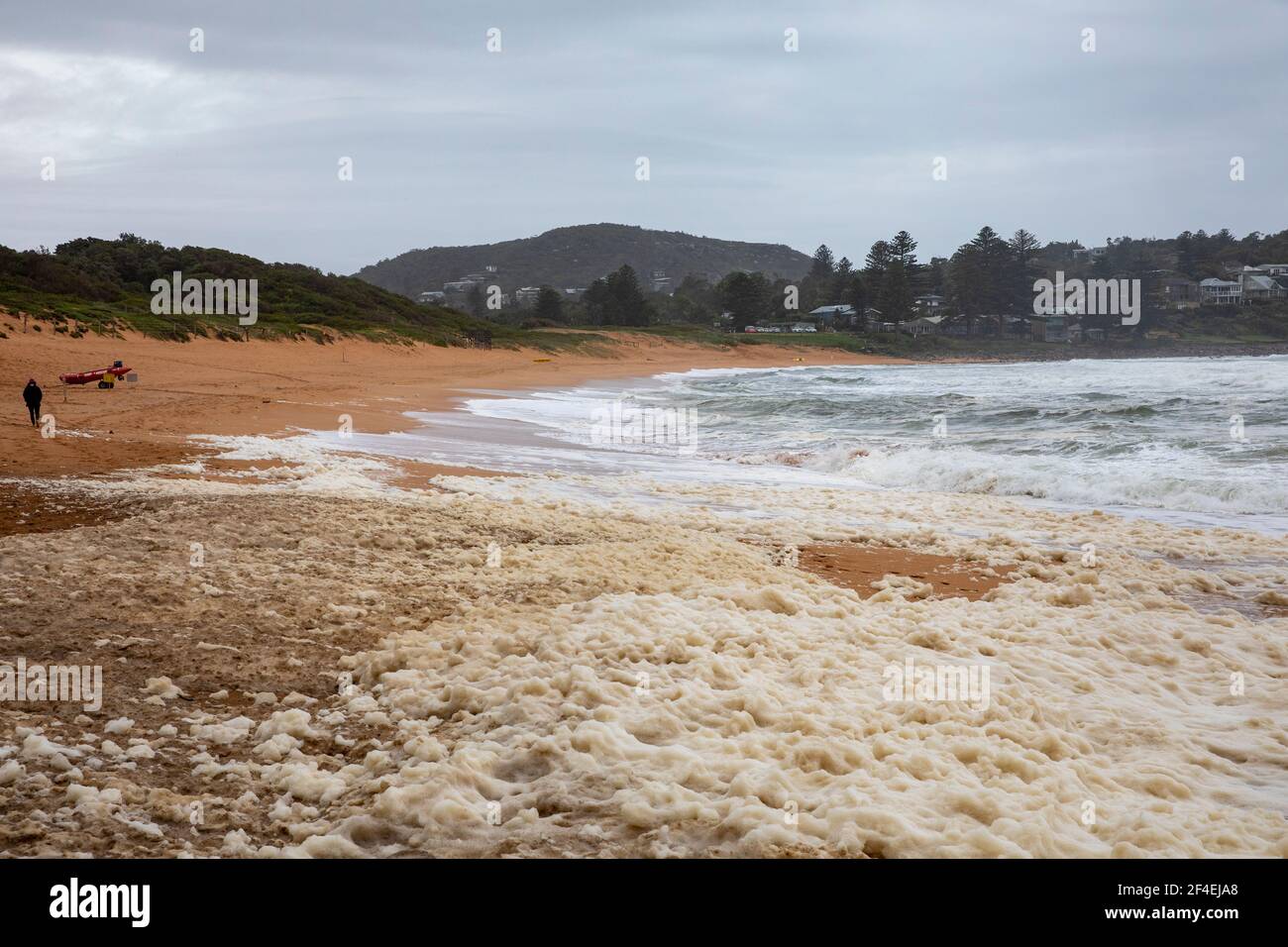 Avalon Beach,Sydney, Australia 21st March 2021.As floods batter New South Wales the east coast surf batters the coastline. Lady walks through the seaf Stock Photo