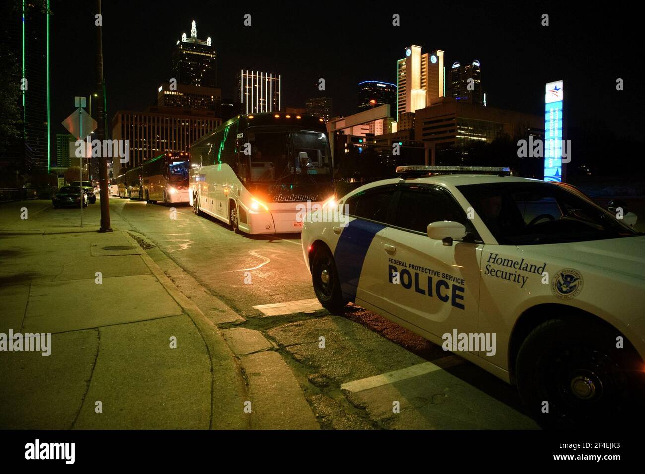 Dallas, Texas, USA. 20th Mar, 2021. Several charter buses carrying migrant teenagers arrived under Federal Protective Service escort to the Kay Bailey Hutchison Convention Center in Dallas on Saturday evening, March 21, 2021.The emergency intake site was opened Wednesday and is expected to hold nearly 3,000 teens, according to the Human and Health Services department. The site in Dallas and one in Midland TX have been opened to alleviate overcrowding at Border Patrol facilities and other HHS-run shelters.The current agreement is for 75 days and allows the use of space at the convention center Stock Photo