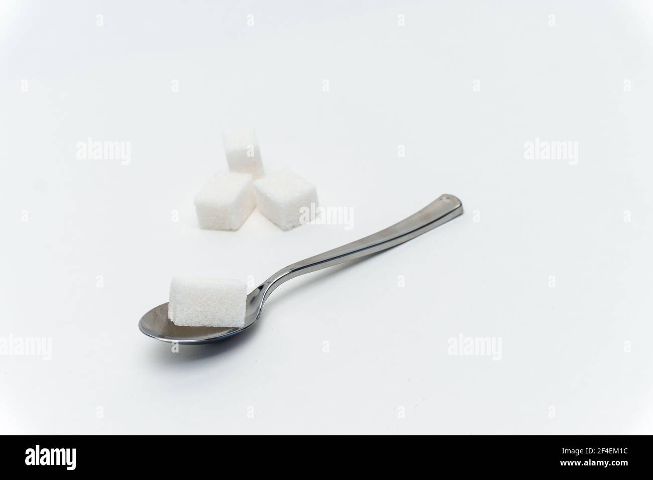 sugar cubes in a teaspoon sweets calorie ingredient Glucose Stock Photo