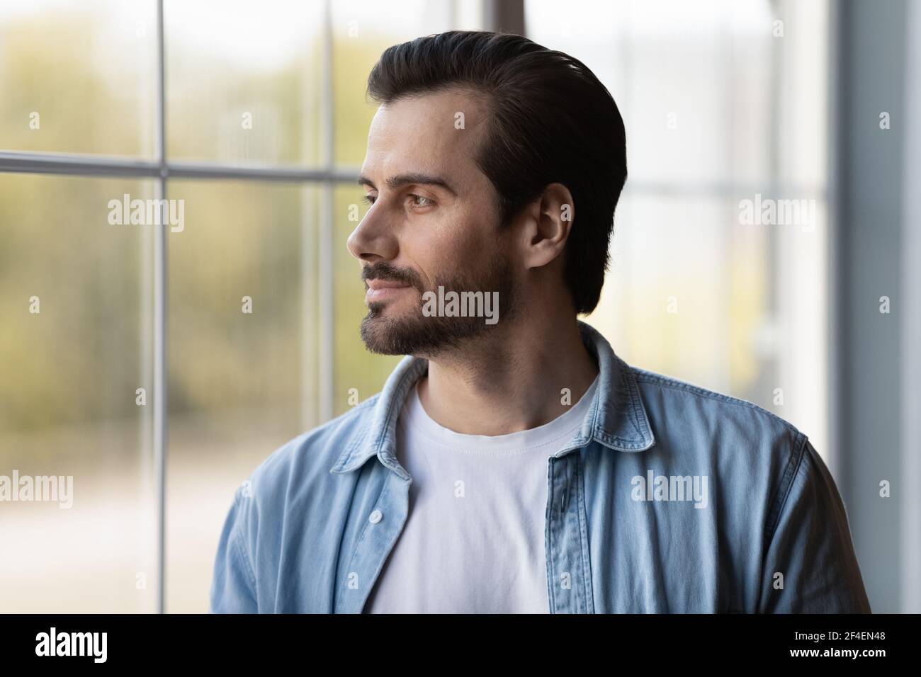 Pensive young man look in distance thinking Stock Photo