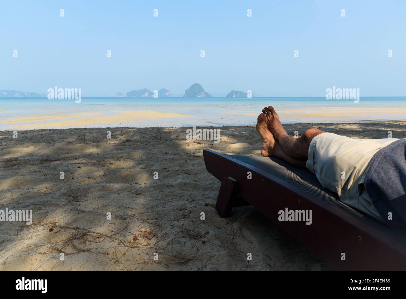 A man lying on the beach chair at Tubkaak beach, Krabi province, Thailand  Stock Photo - Alamy