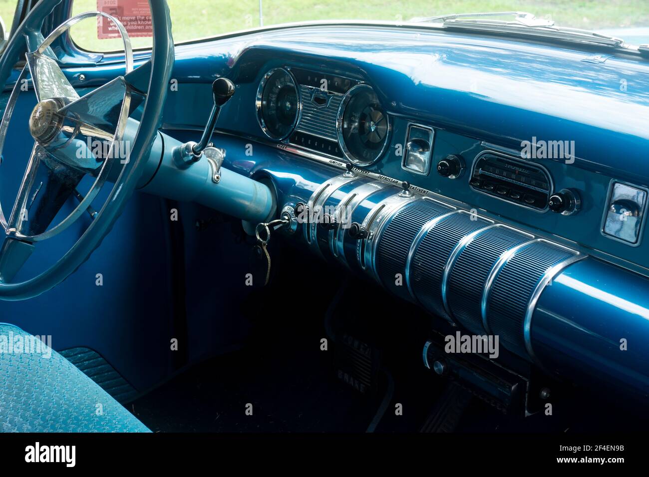 Dashboard and interior of a restored classic 1955 Buick with knobs and