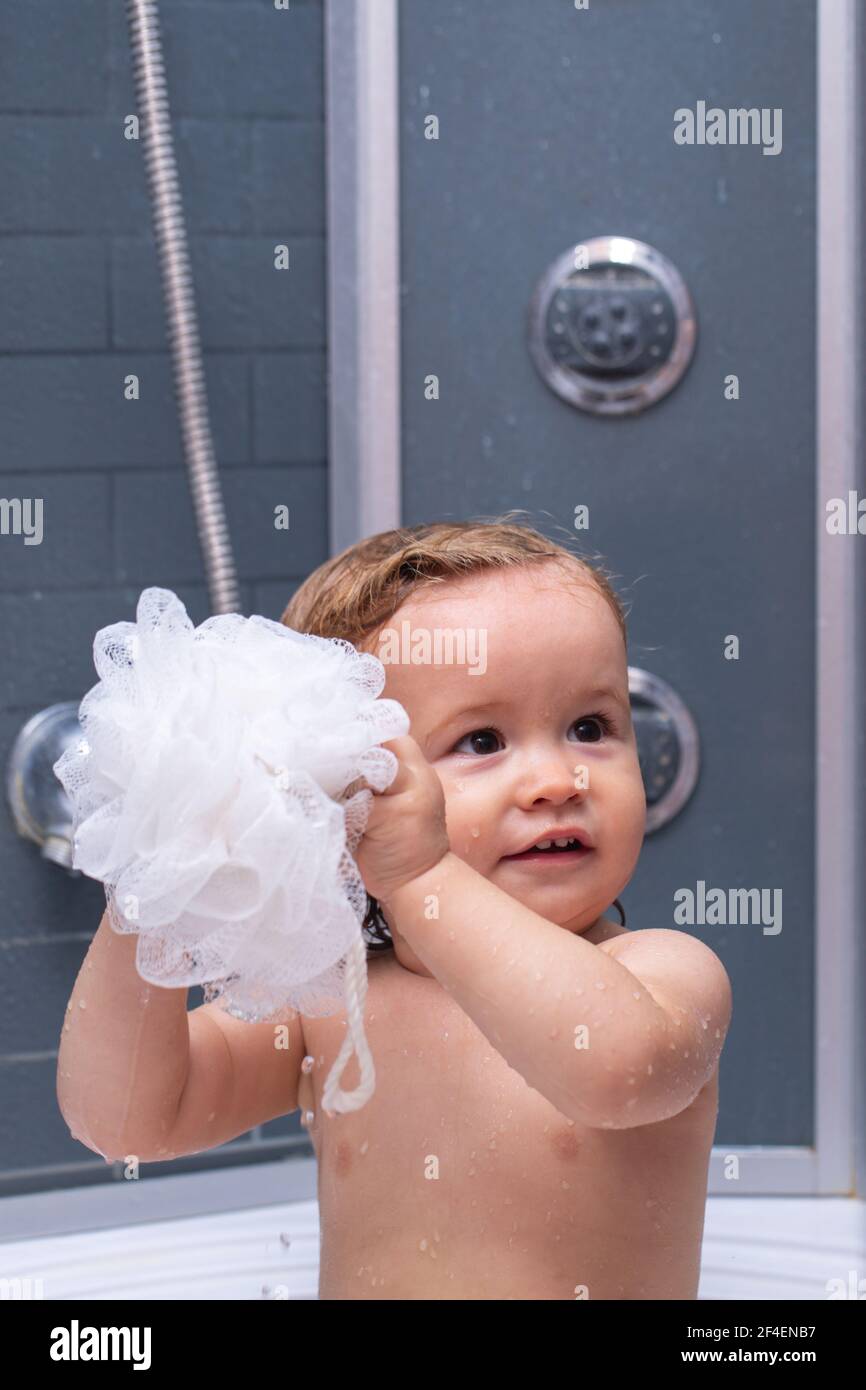 Child in shower. Baby showering. Portrait of kid bathing in a bath with