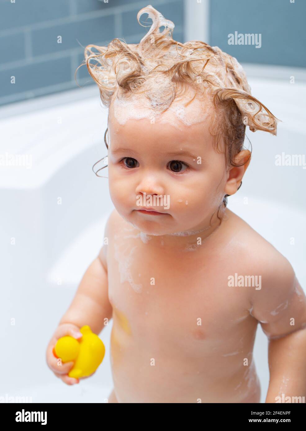 Funny blond kid boy having fun with water by taking bath in bathtub.  Washing adorable baby in bathroom. Kid with soap suds on hair taking bath.  Kids Stock Photo - Alamy