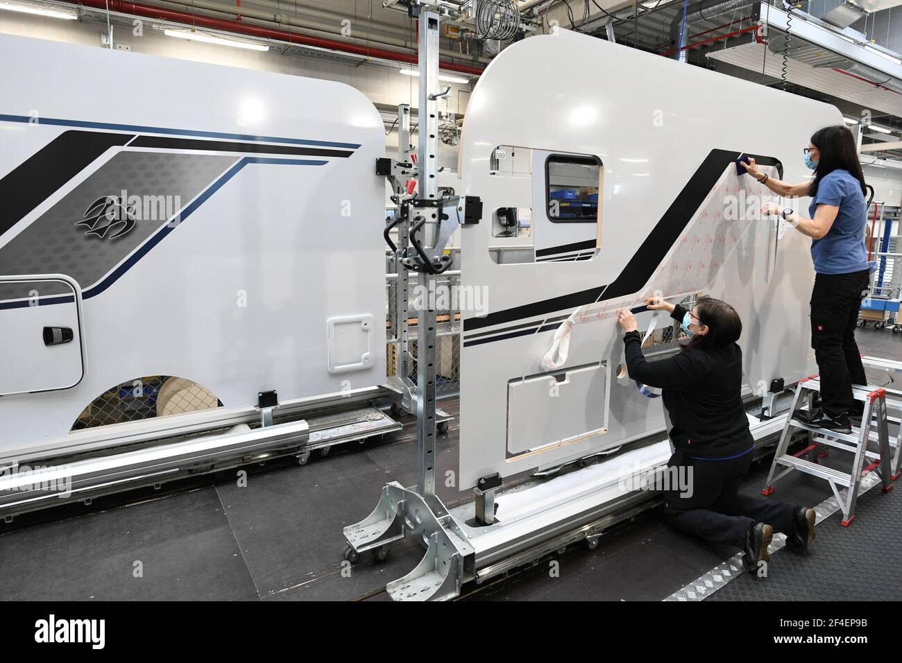 Workers add decals on camper walls at the Knaus-Tabbert AG factory in  Jandelsbrunn near Passau, Germany, March 16, 2021. Picture taken March 16,  2021. REUTERS/Andreas Gebert Stock Photo - Alamy