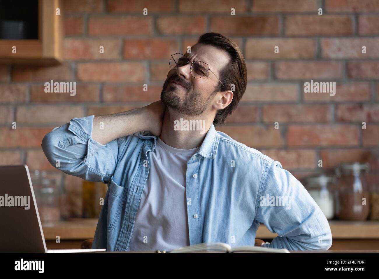 Unwell man suffer from backache working on computer Stock Photo