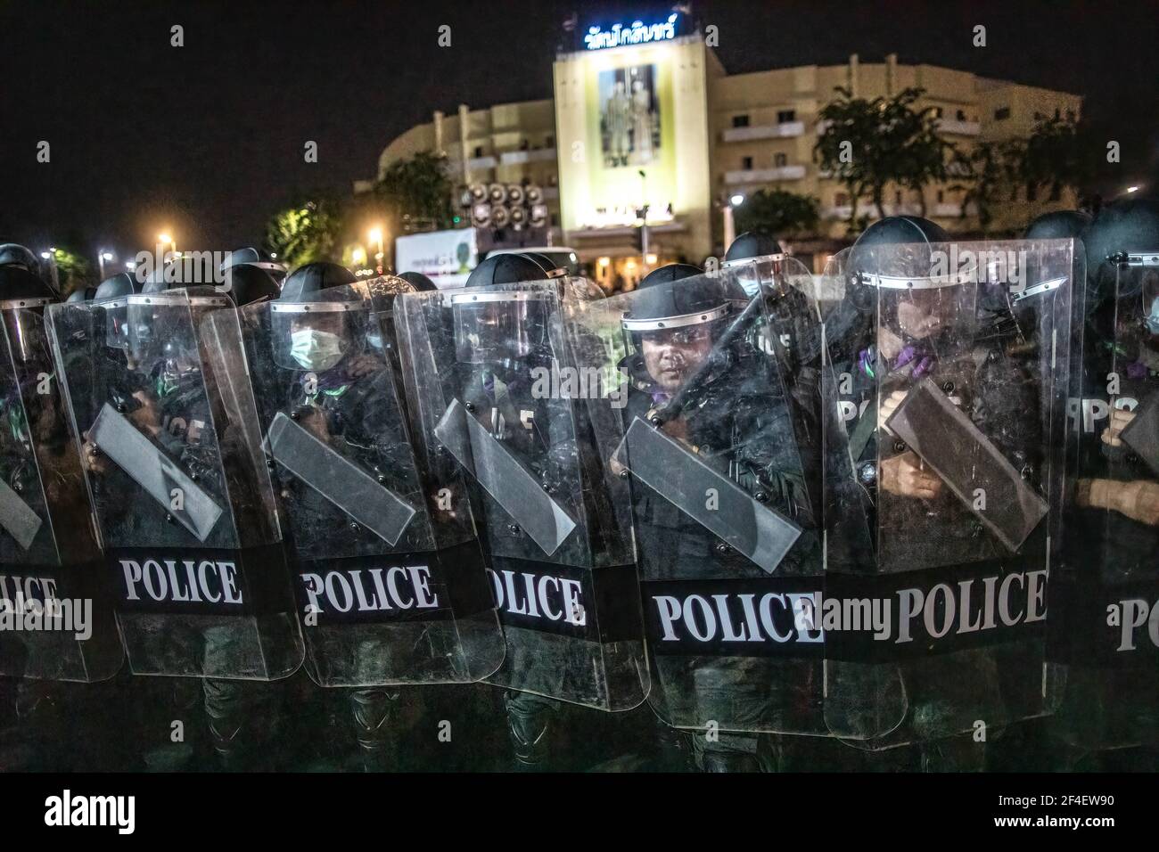 Riot police officers stands guard behind their shields during an anti-government demonstration in Bangkok. Thousands of pro-democracy protesters gathered near the Grand Palace in Sanam Luang demanding the resignation of Thailand Prime Minister and the reform of the monarchy. The protesters also denounced the use of the Lese Majeste law under the section 112 of the penal code. The protest organized by REDEM (Restart Democracy) ended up with several clashes, the use of water cannon, tear gas and rubber bullet, which had left several injured. Stock Photo