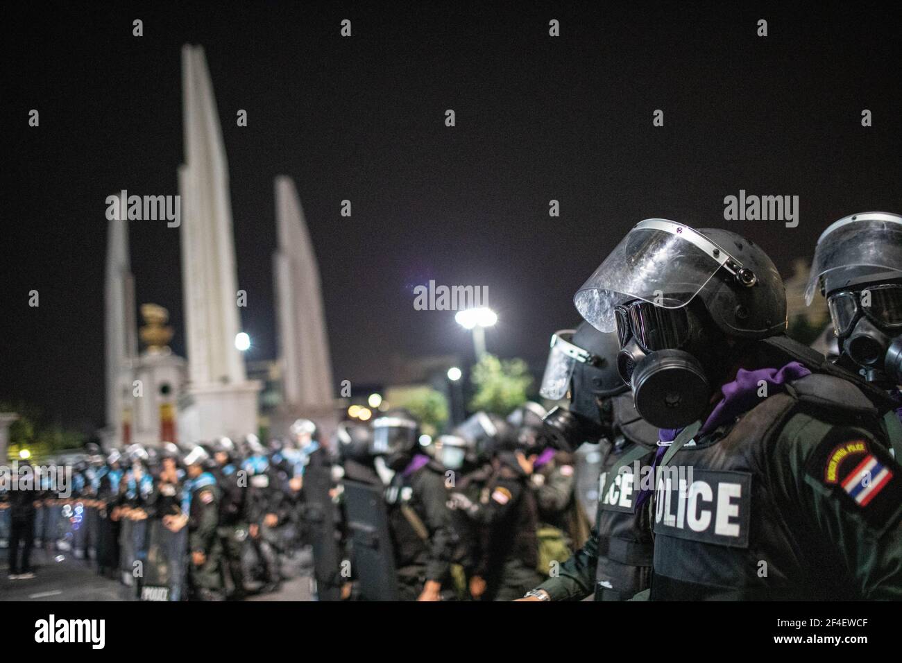 Riot police officers wearing gas mask stand guard near the Democracy Monument during an anti-government demonstration in Bangkok. Thousands of pro-democracy protesters gathered near the Grand Palace in Sanam Luang demanding the resignation of Thailand Prime Minister and the reform of the monarchy. The protesters also denounced the use of the Lese Majeste law under the section 112 of the penal code. The protest organized by REDEM (Restart Democracy) ended up with several clashes, the use of water cannon, tear gas and rubber bullet, which had left several injured. Stock Photo