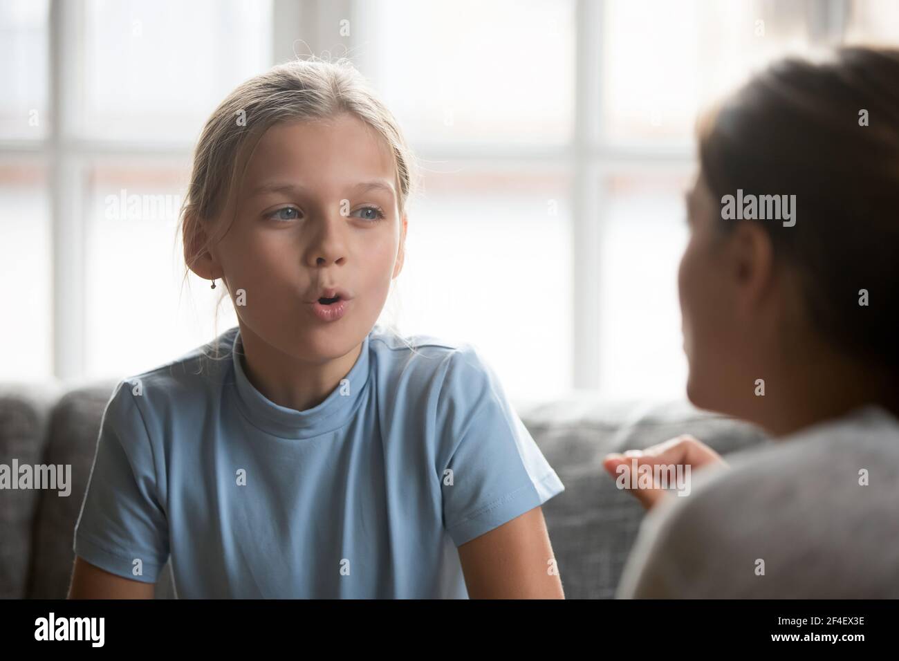 Teen girl child learn pronunciation with tutor Stock Photo