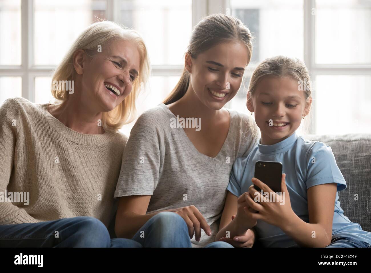 Happy three generations of women use smartphone gadget Stock Photo - Alamy