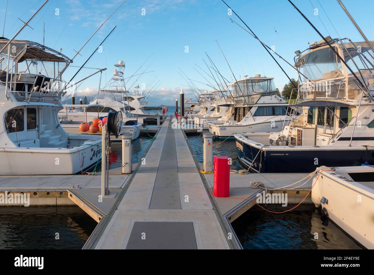Deep sea fishing boats moored at the marina beside Bermagui Fisherman's Wharf in the late afternoon on the New South Wales south coast in Australia Stock Photo