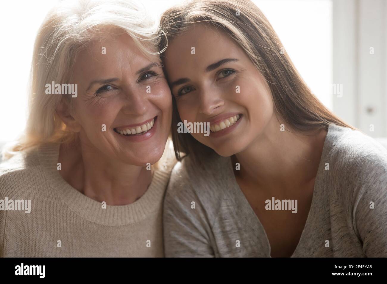 Headshot portrait of happy mature mom and adult daughter Stock Photo