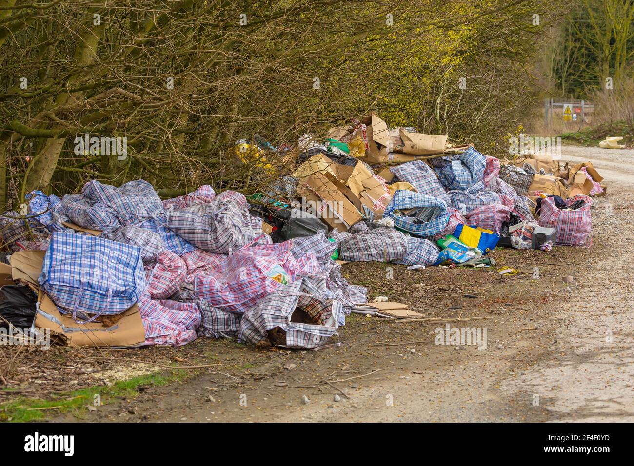 Yorkshire,England, 20/03/21. Fly-tipping down a quiet country lane.  Extreme amount of household and garden waste illegally dumped in open countryside Stock Photo
