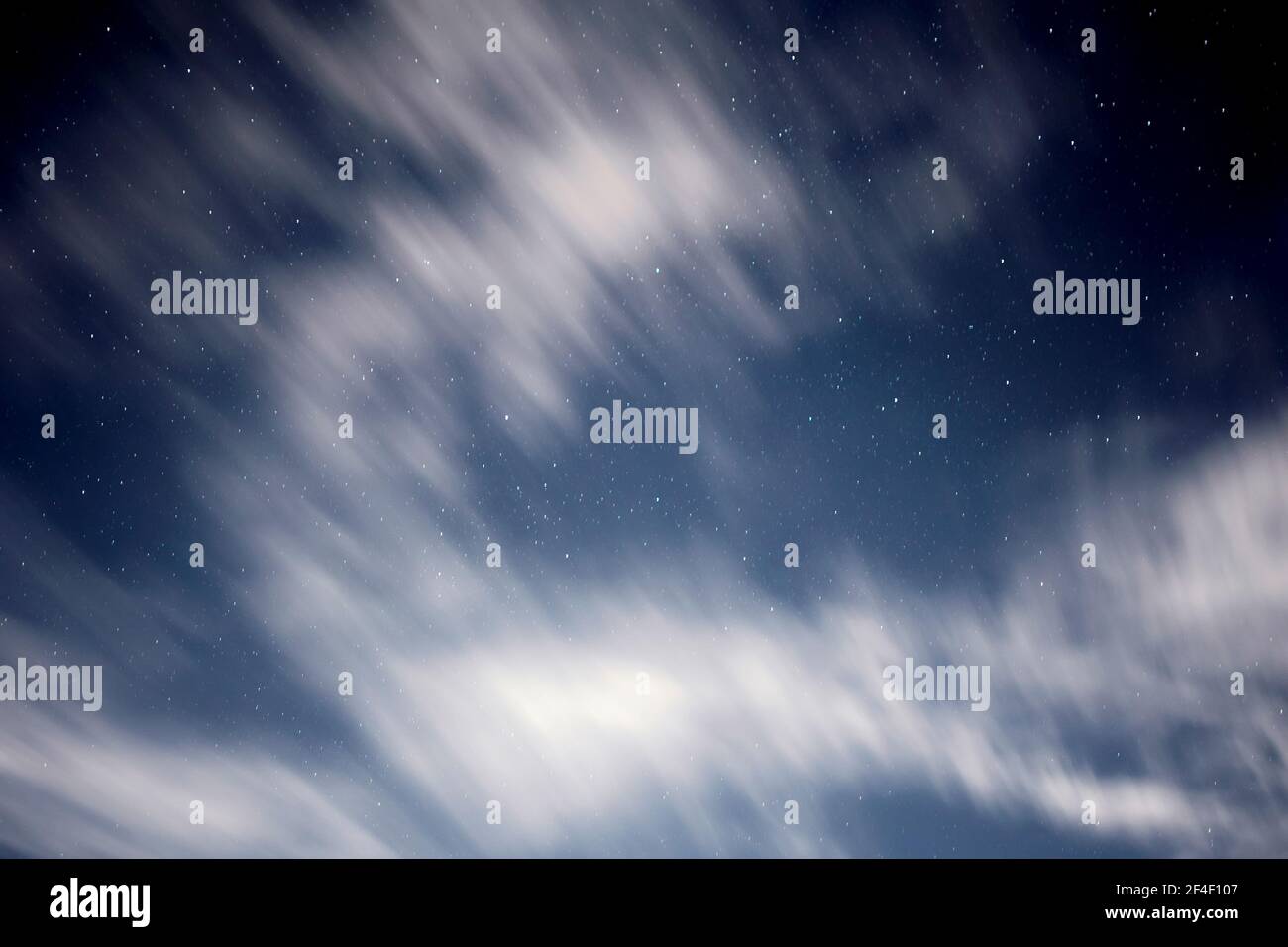 Blurry clouds floating in the sky during evening with stars. Used long exposure. Stock Photo