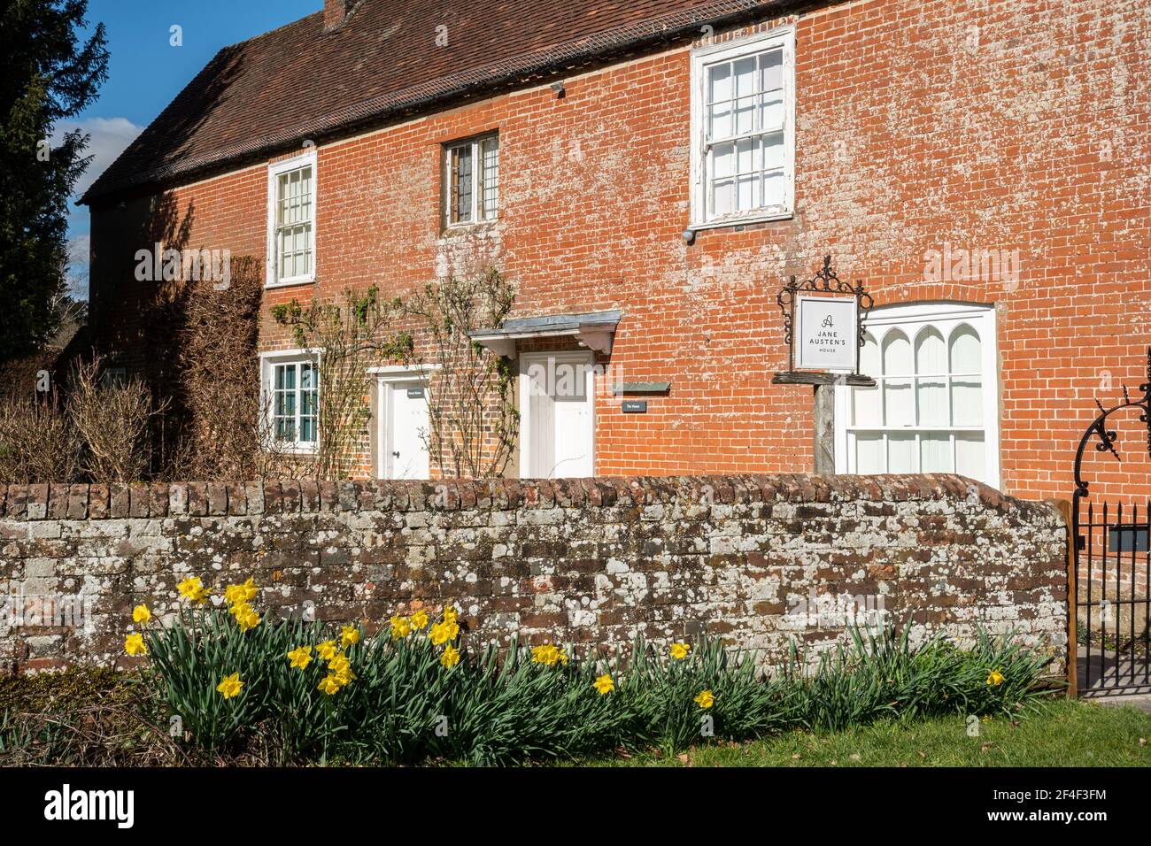 Jane Austen's House and museum in Chawton, Hampshire, England, UK, during spring with daffodils in flower Stock Photo