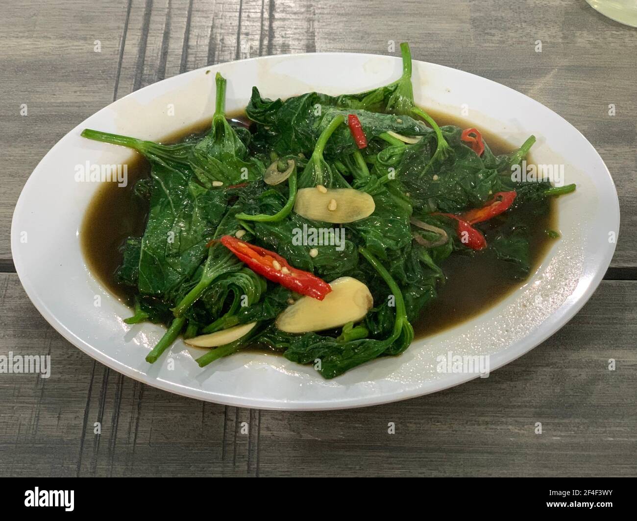 Closeup of cah kangkung, kangkong, or water spinach stirred. Stock Photo