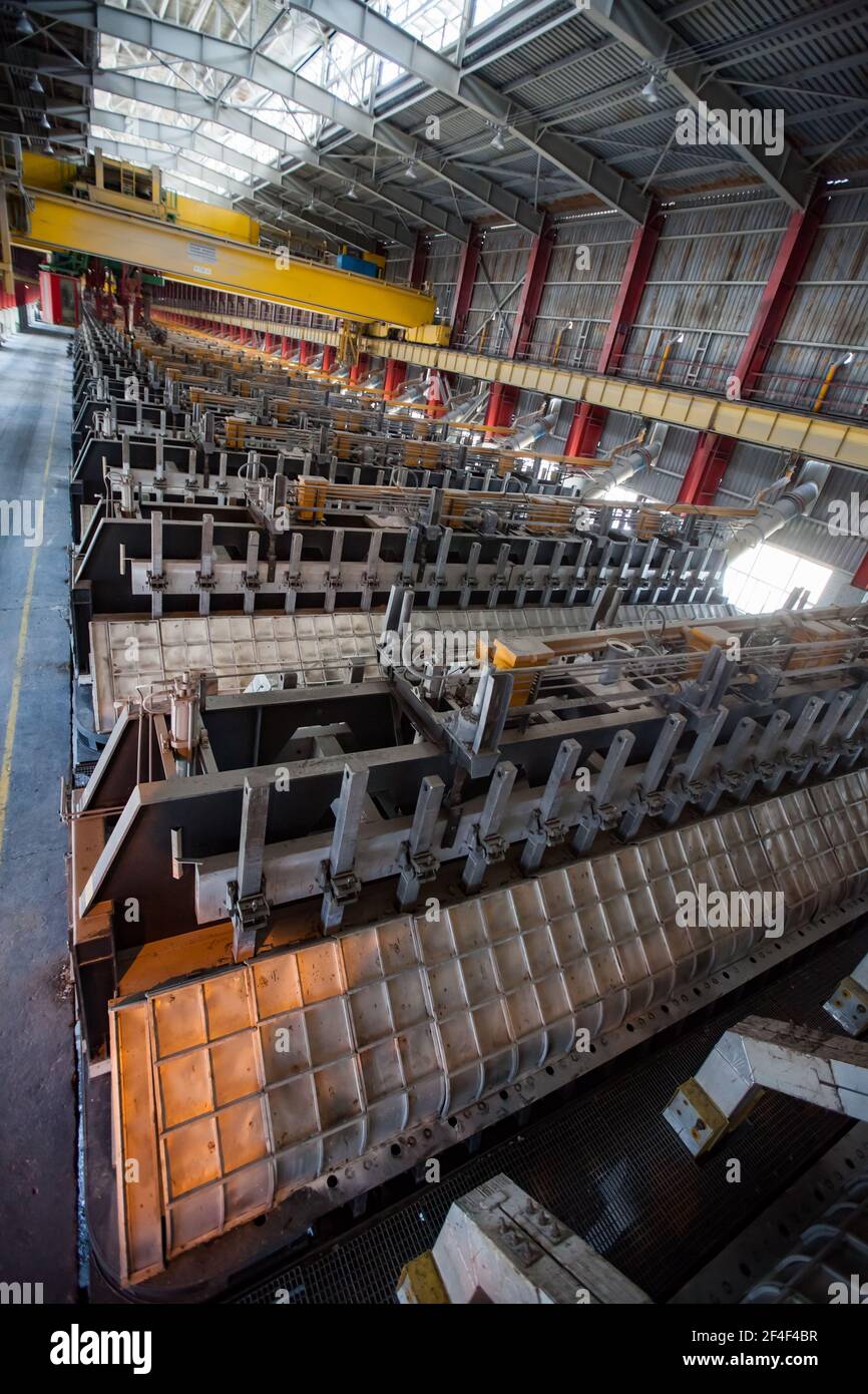 Aluminum electrolysis plant. Panorama view of factory workshop with overhead crane. Stock Photo