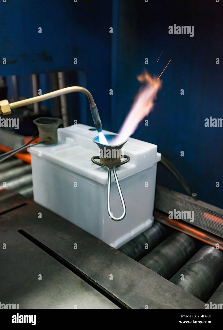 Accumulator recycling plant. Foundry plumb storage battery terminals with gas-burner. Stock Photo