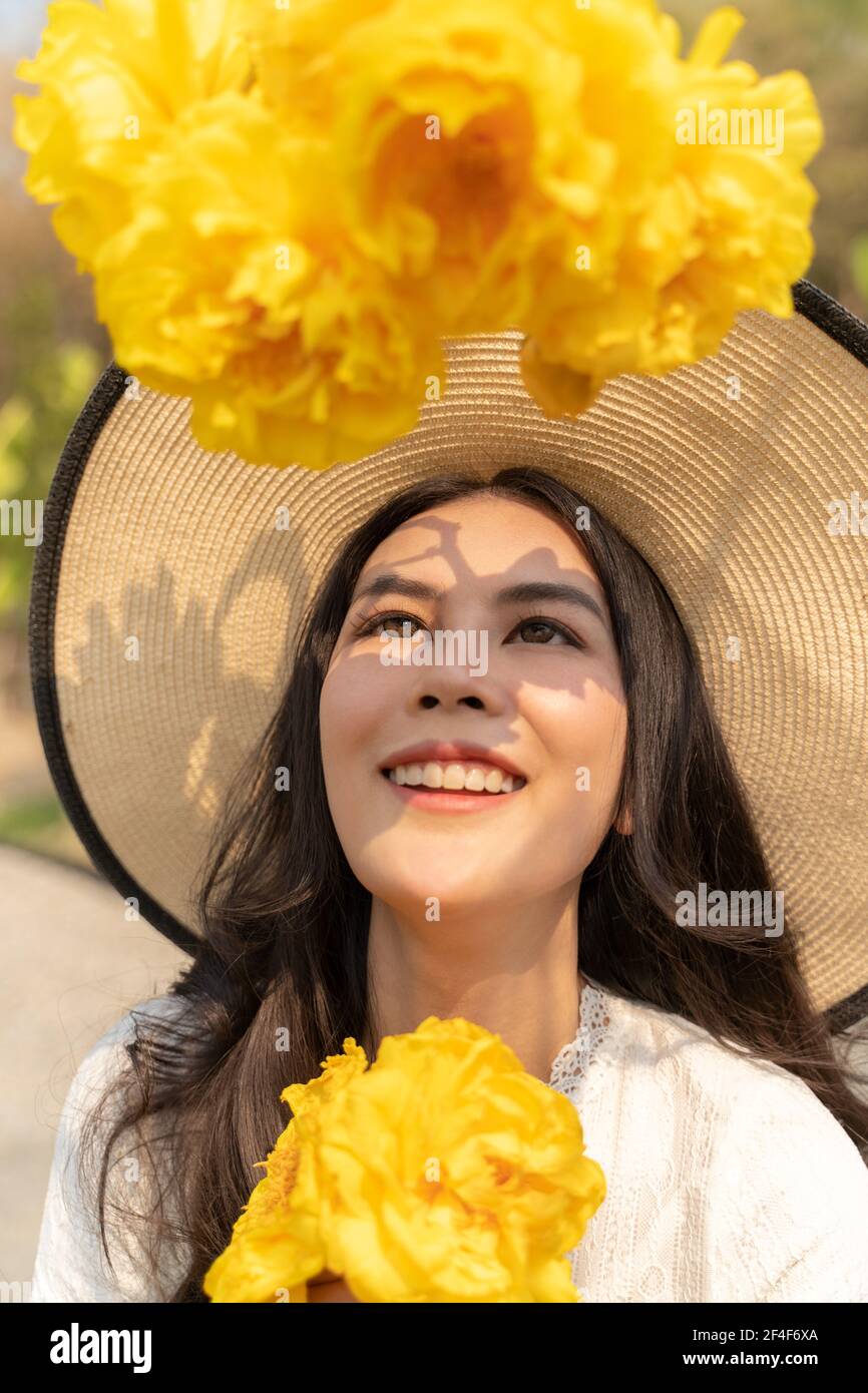 Portrait of happy young beautiful woman wearing big straw hat and white ...